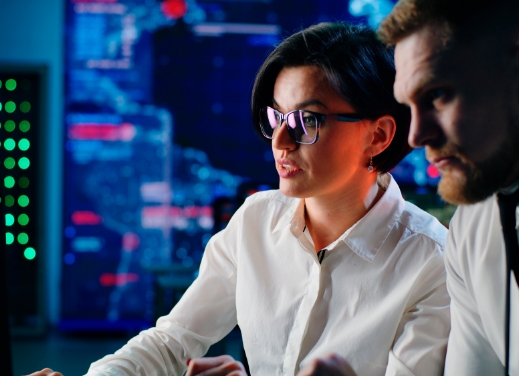 Woman and man programmers looking at a the same computer screen.